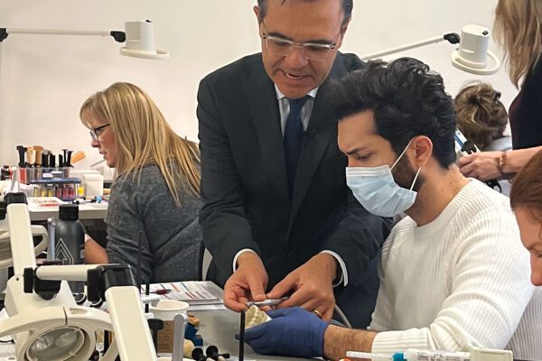 Dr. Javier Quiros guides a dental CD attendee on creating a bevel in his full mouth composite restoration course at Cosmedent Center for Esthetic Excellence.