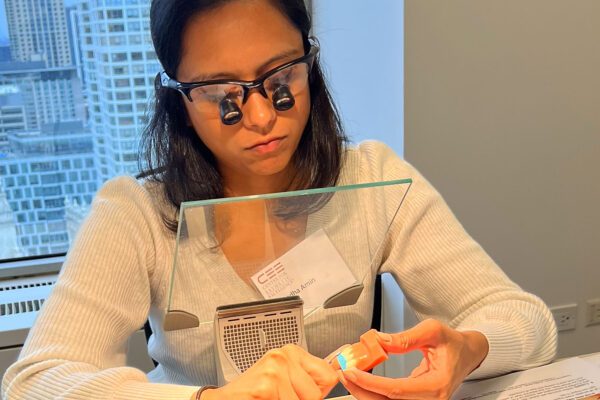 A dental CE student cuts her putty matrix to practice her anterior composite restoration skills at the Center for Esthetic Excellence at Cosmedent.