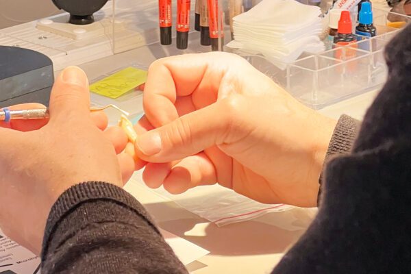 A course attendee applies a composite tint to their anterior composite restoration in a hands-on exercise at Cosmedent's Center for Esthetic Excellence.