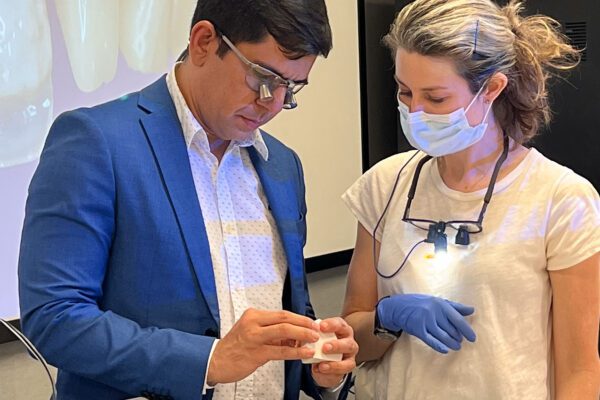 Dr. Kelcio Alves inspects the work done by a dental CE student in his composite bonding course at the Center for Esthetic Excellence at Cosmedent.